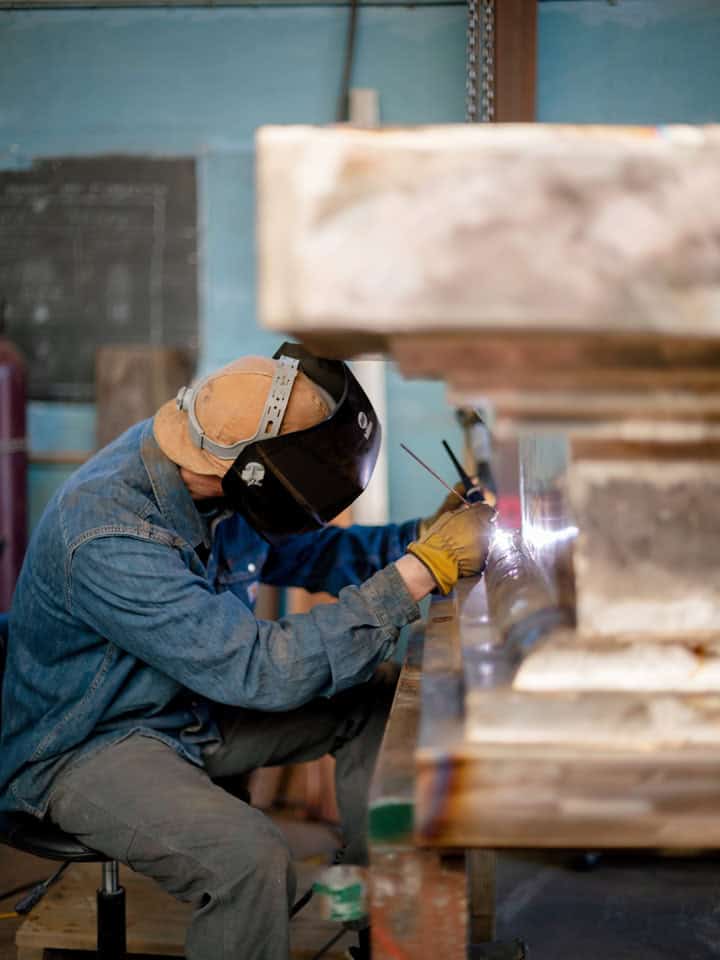Welding and metal finishing on cast bronze sculpture/stupa