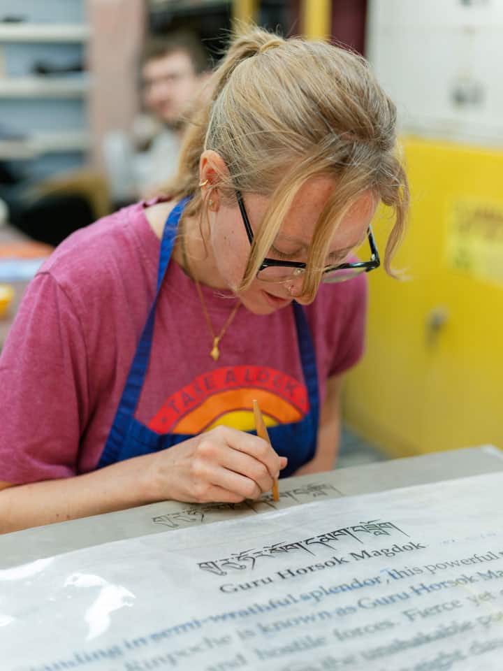 hand carving Tibetan text for plaque for bronze statue