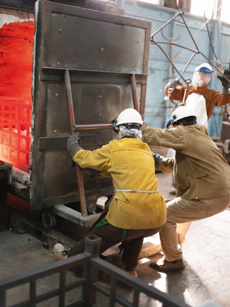 Foundry volunteer working bronze casting production, Odiyan Buddhist retreat